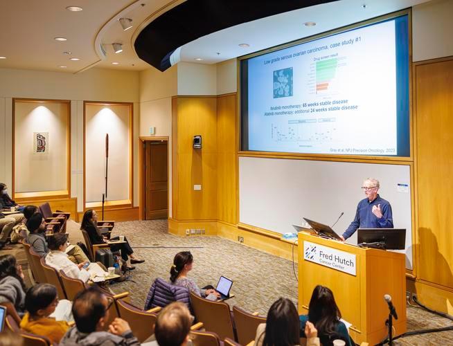 Dr. Christopher Kemp speaking at podium