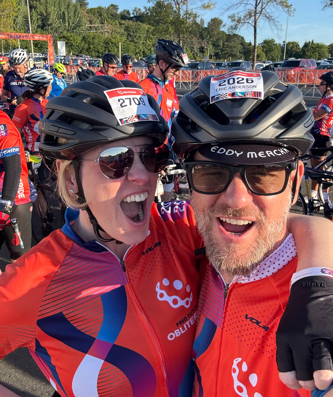Two people with cycling gear and sunglasses