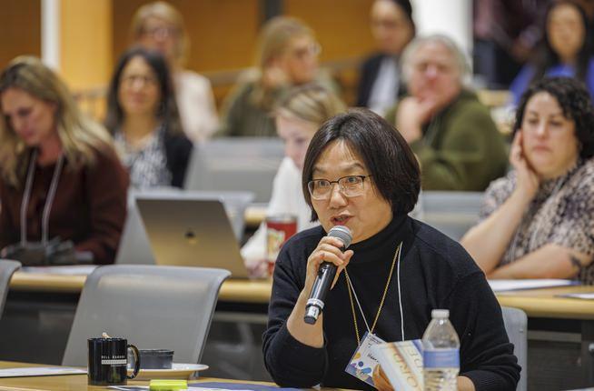 Cancer patient advocate Ting Ting Zhang asks a question during Fred Hutch's Value in Cancer Care Summit, held November 6.